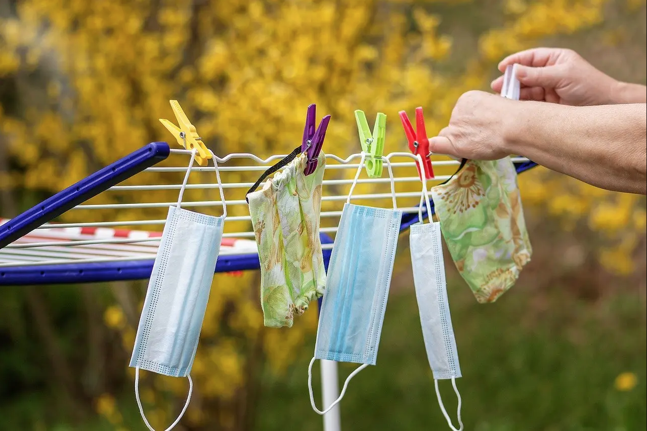 Various colored non-medical grade PPE masks drying on clothesline