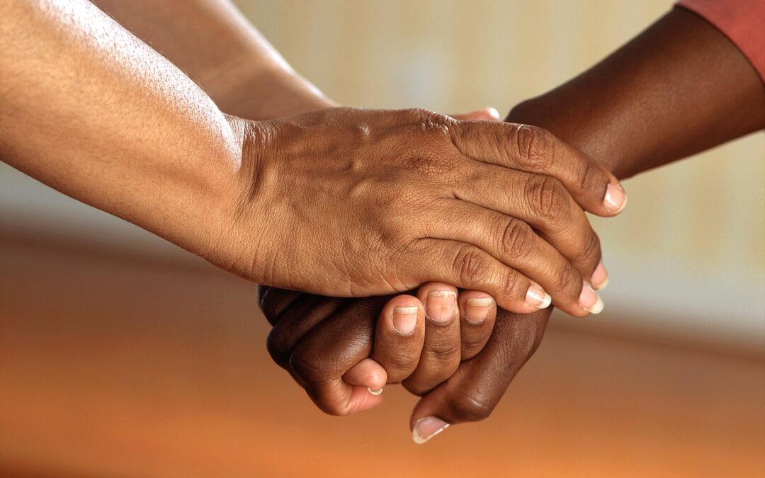 A hand being held by another showing compassion