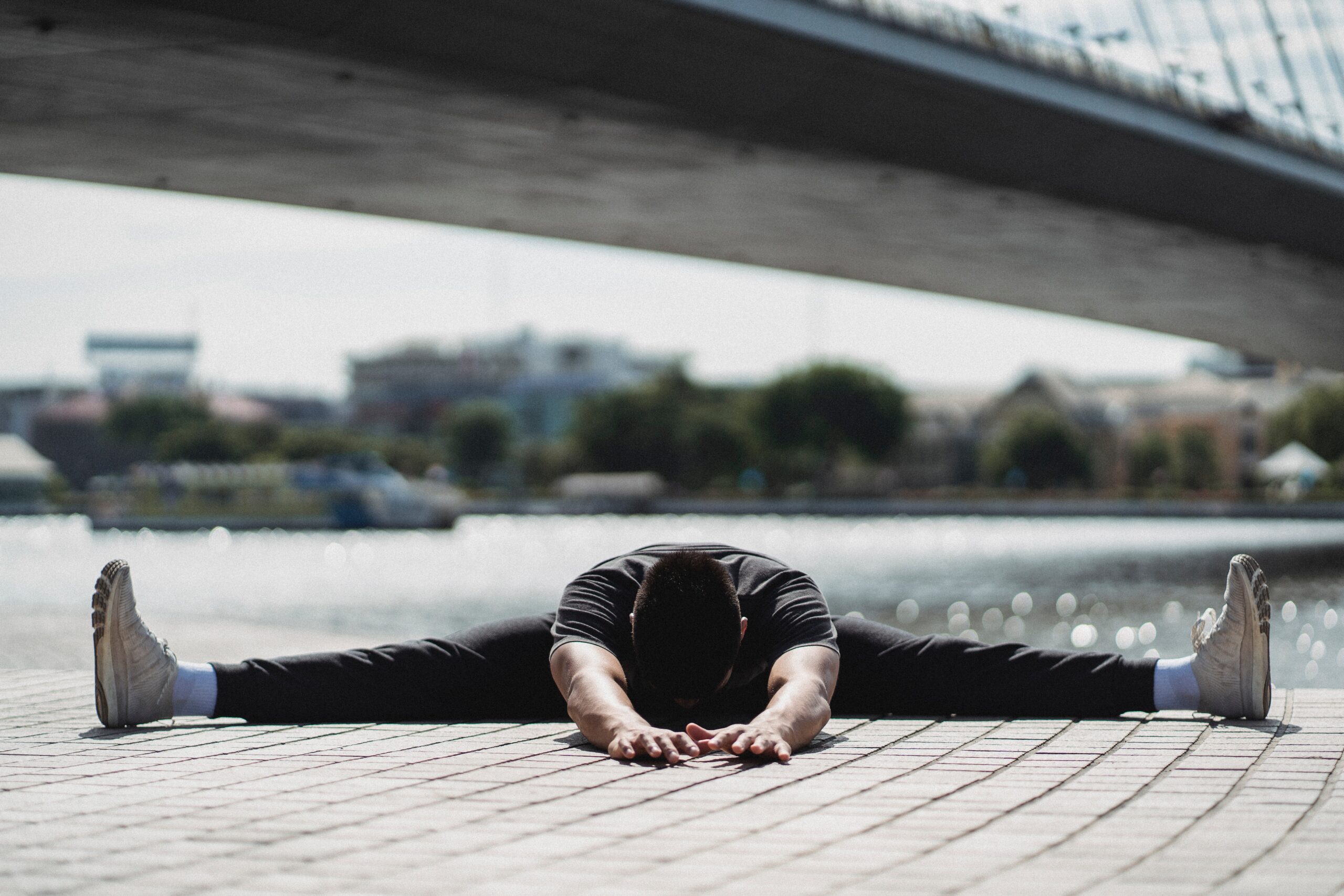 A male in yoga position with arms and feet on laid on the floor