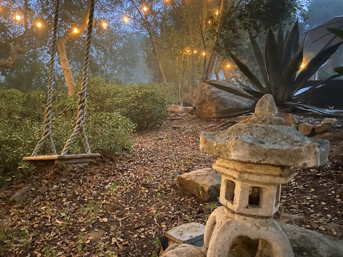 lighted path with swing and trees