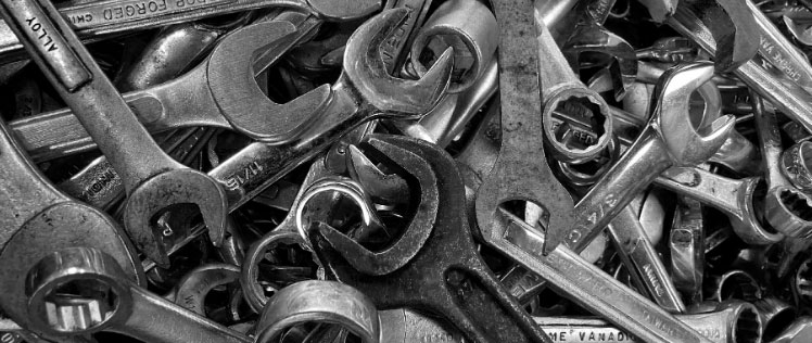 Black and white picture of a pile of wrenches